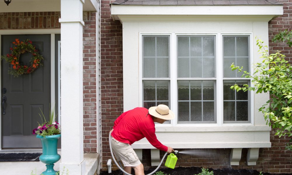 Man,Cleaning,The,Underside,Of,A,Bay,Or,Bump-out,Window